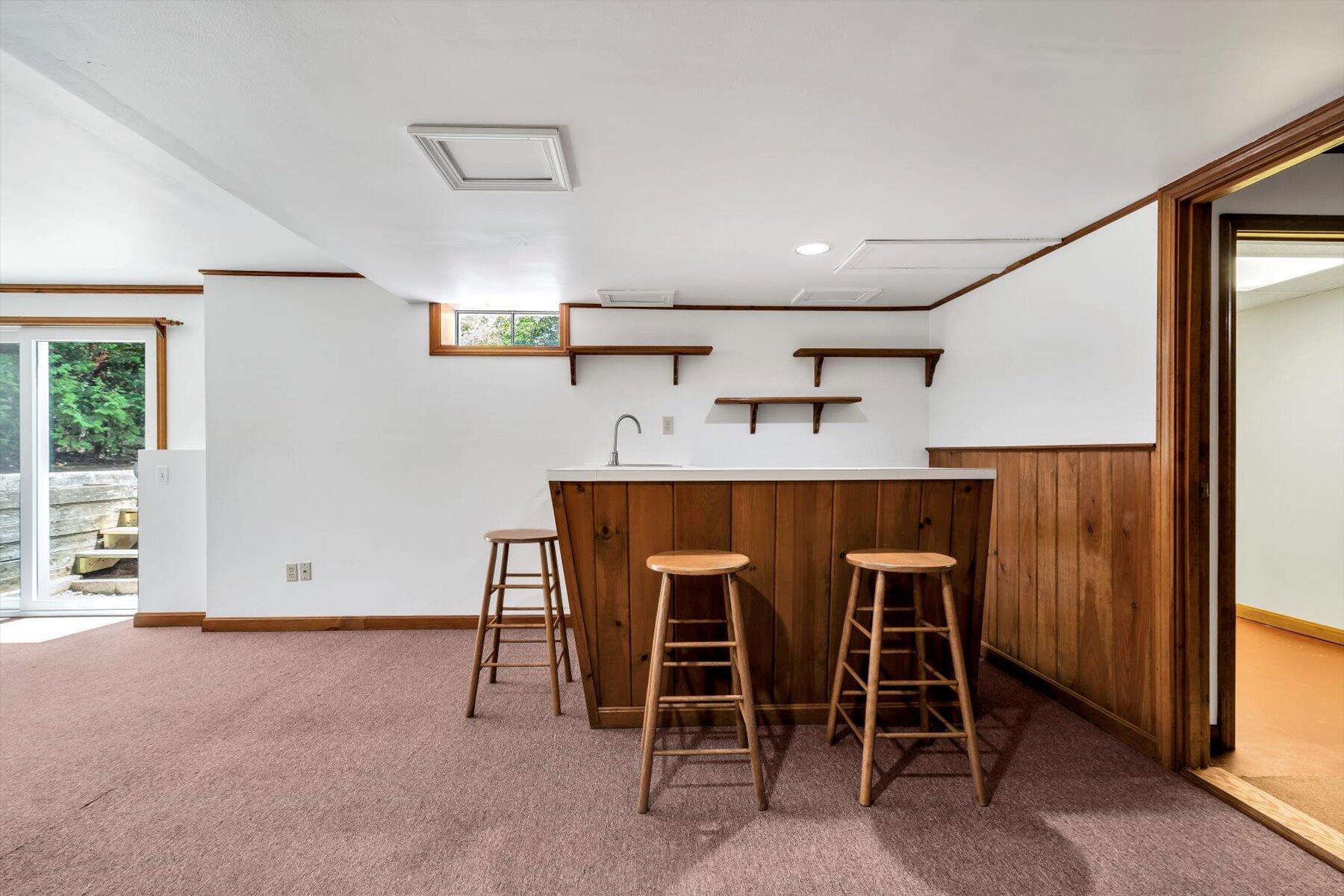 18 Pheasant Run Road Harwich, MA 02645 - Photo 29 of 51 a kitchen with kitchen island a dining table chairs cabinets and stainless steel appliances