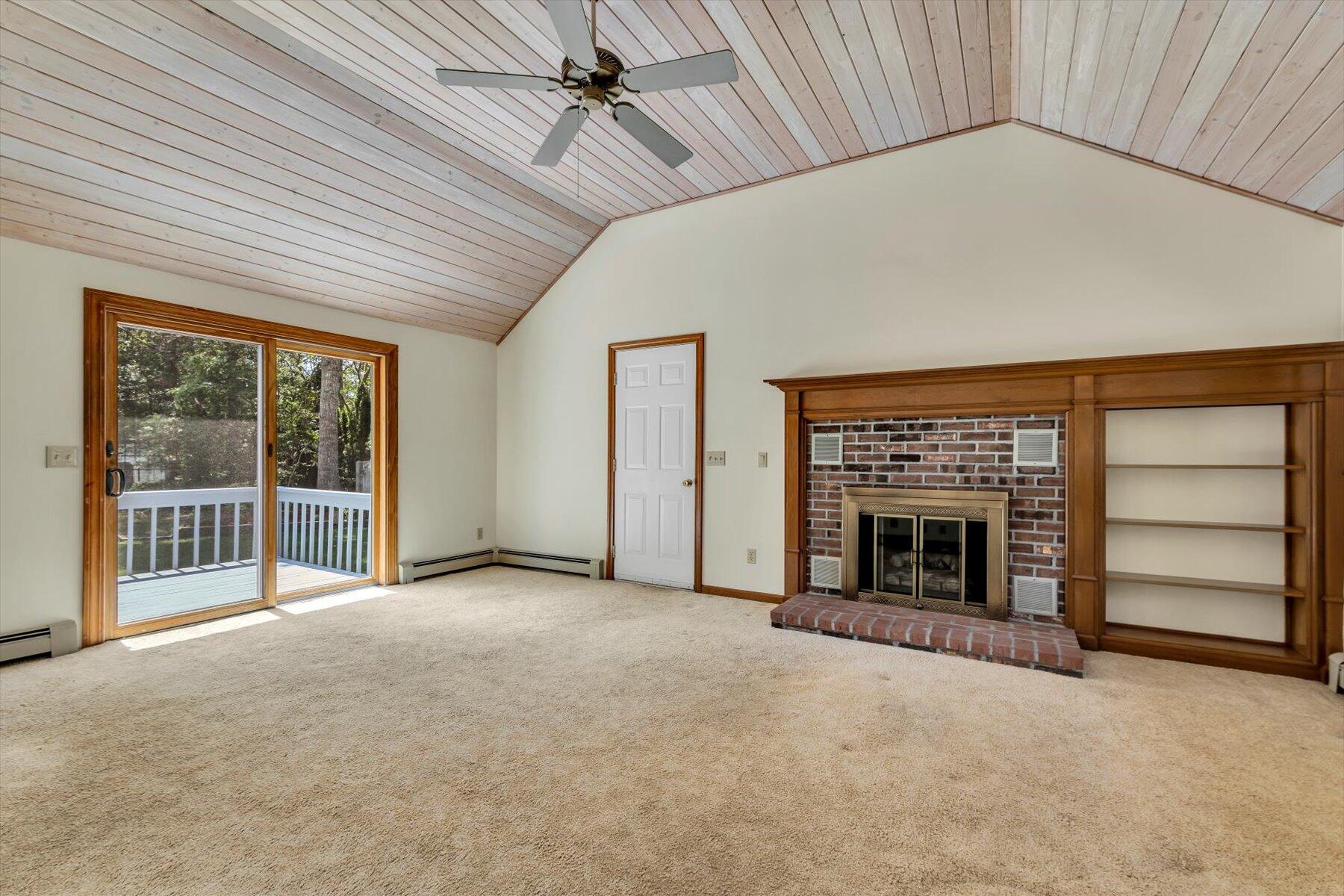 18 Pheasant Run Road Harwich, MA 02645 - Photo 3 of 51 an empty room with furniture and a fireplace