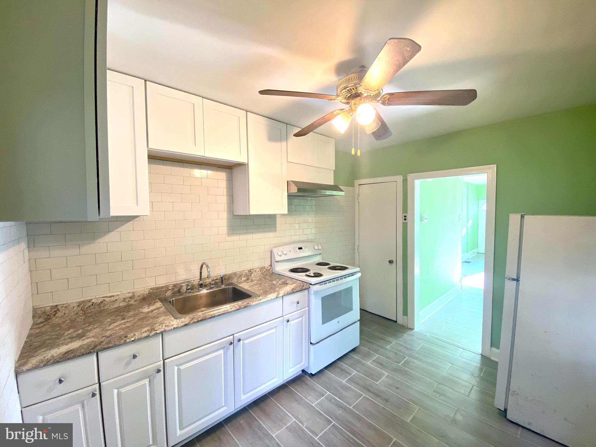 1107 West Colona Street Philadelphia, PA 19133 - Photo 1 of 10 a kitchen with a sink cabinets stainless steel appliances and a window