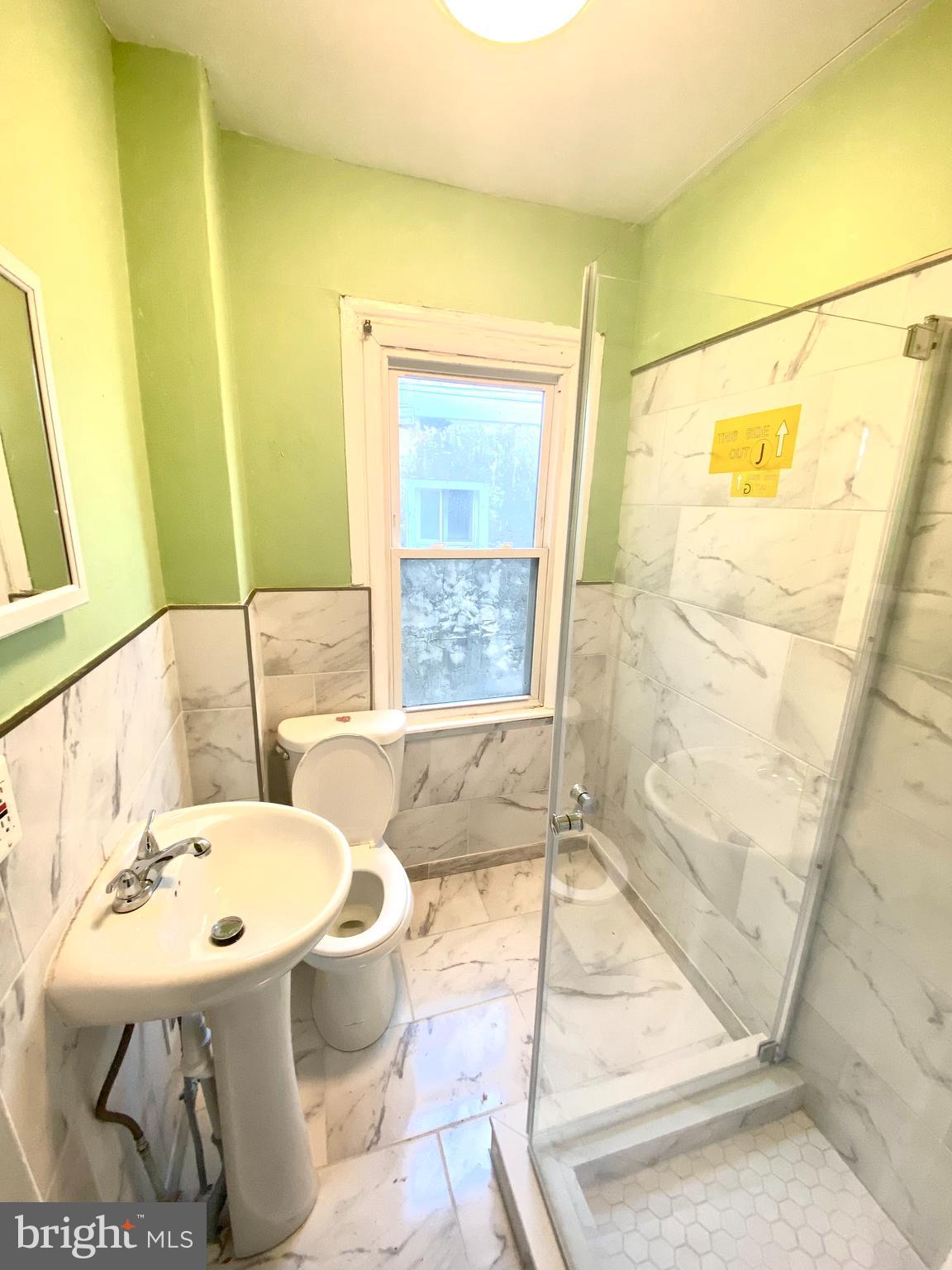 1107 West Colona Street Philadelphia, PA 19133 - Photo 6 of 10 a bathroom with a sink toilet and shower