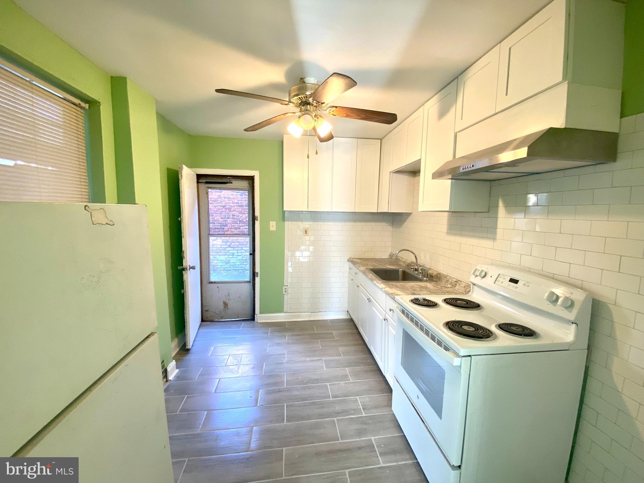 1107 West Colona Street Philadelphia, PA 19133 - Photo 7 of 10 a kitchen that has a stove and a refrigerator