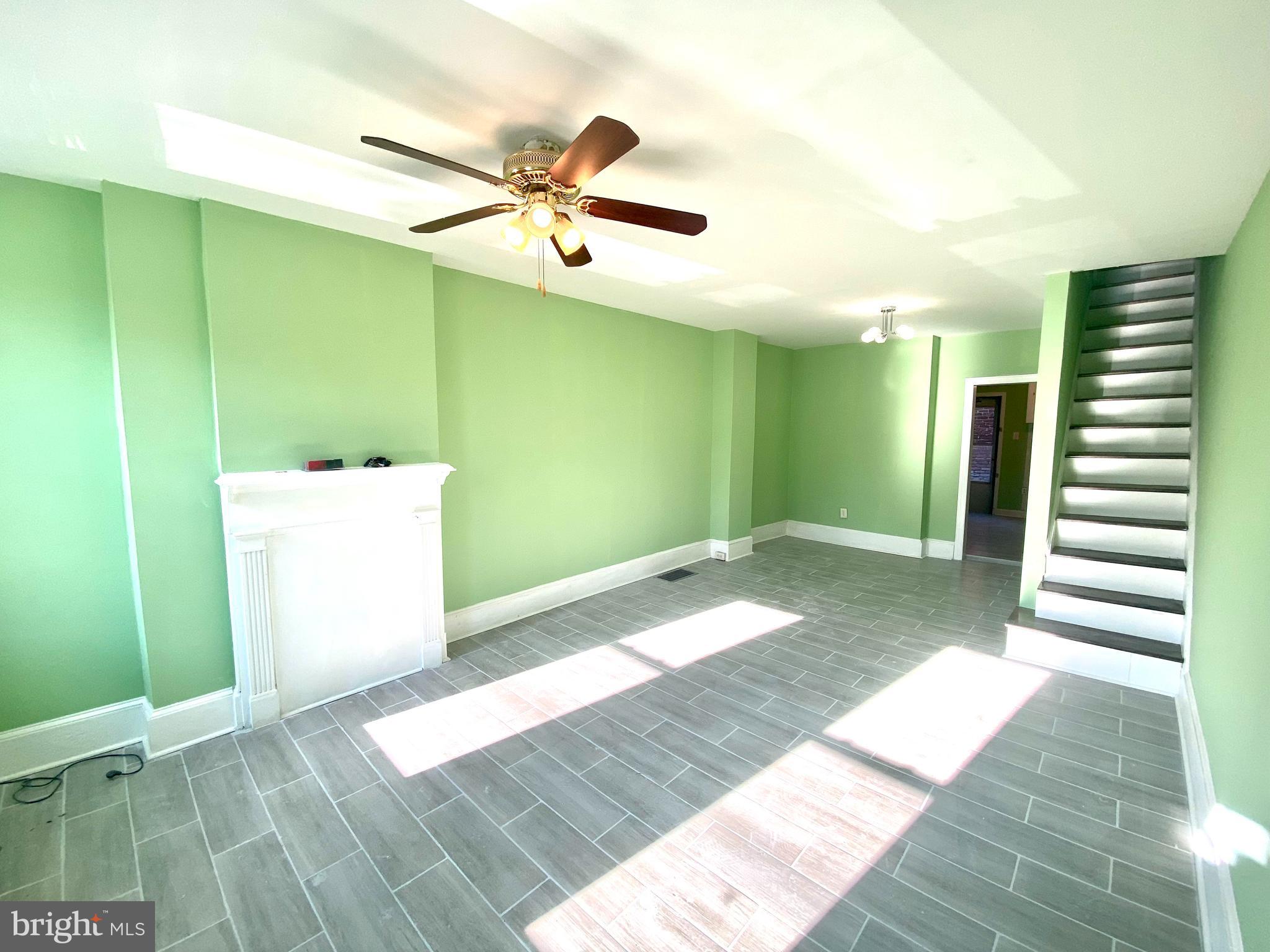 1107 West Colona Street Philadelphia, PA 19133 - Photo 8 of 10 a view of a hallway with stairs and wooden floor