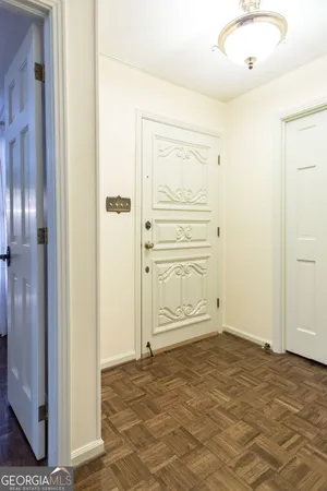 a view of a hallway with wooden floor