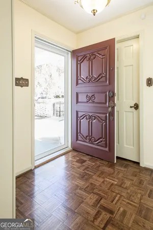 a view of empty room with wooden floor