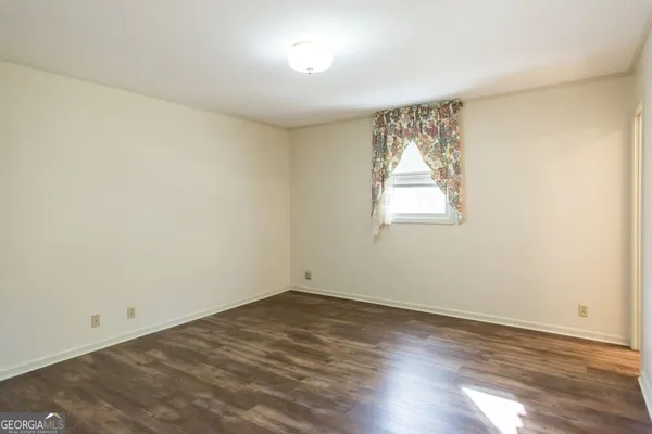 a bathroom with a sink a toilet and shower curtain