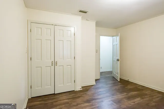 a view of an entryway with wooden floor and a ceiling fan