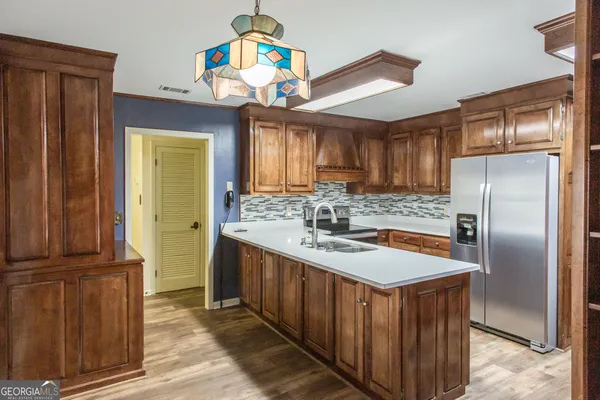 a view of kitchen with sink and cabinets