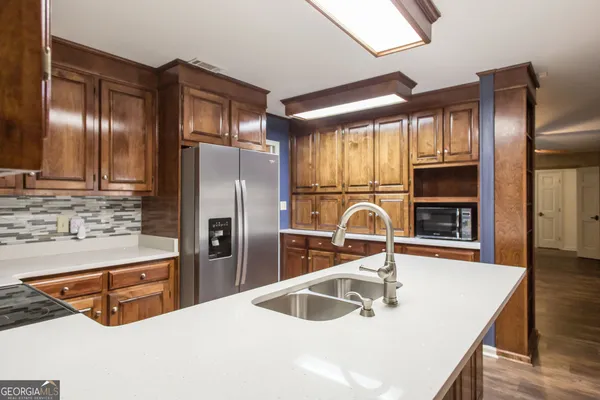 a kitchen with a stove a sink and a window