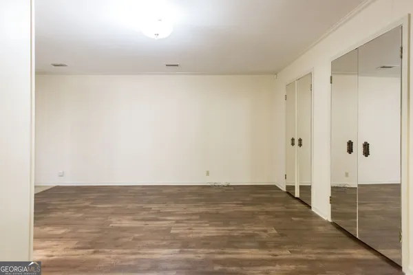 a bathroom with a granite countertop sink mirror vanity and toilet