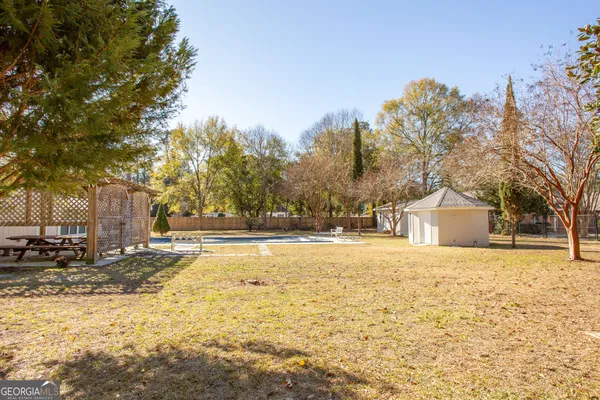 a big house with a big yard and large trees