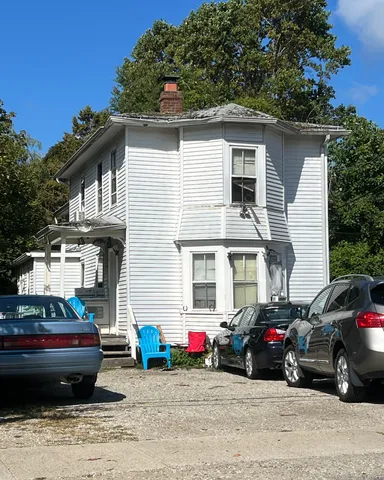 a view of a car park in front of a house