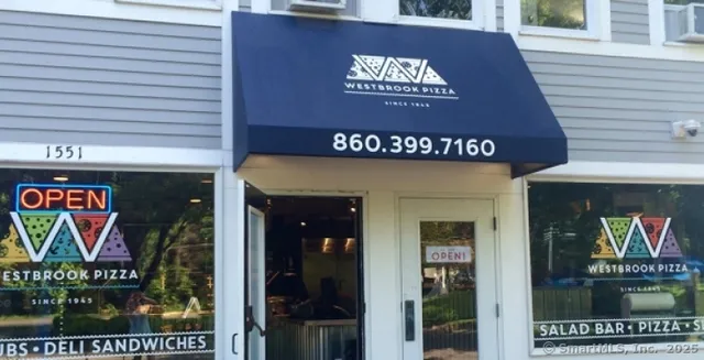 a view of a door with glass door and sign