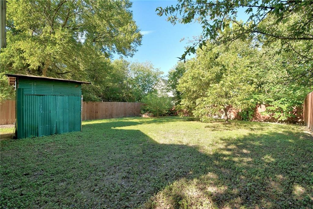 1120 Estes Avenue, Unit B Austin, TX 78721 - Photo 21 of 26 Fenced backyard with a storage unit