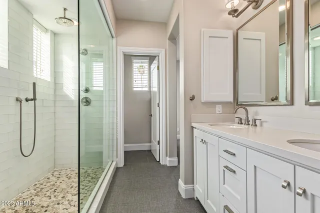 a bathroom with a shower sink and mirror