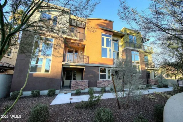 a view of a brick building next to a yard