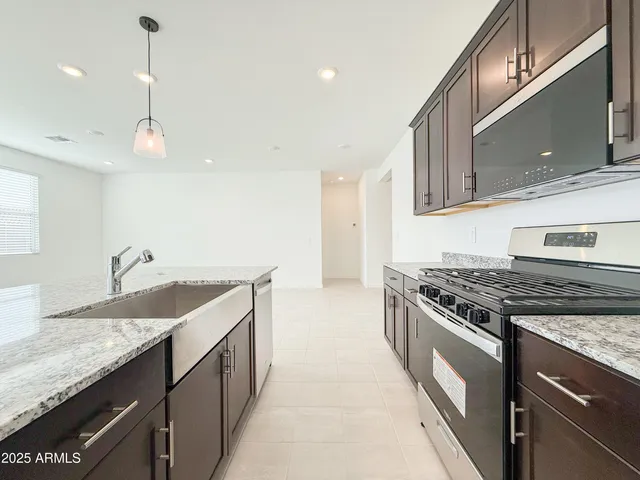 a kitchen with a sink stove and microwave