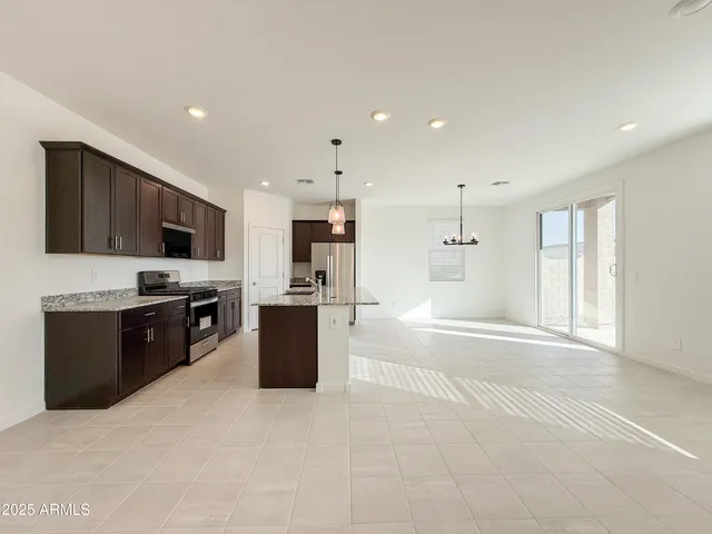 a large kitchen with stainless steel appliances lots of counter top space and appliances