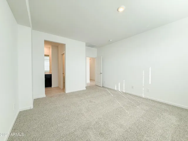 an empty room with an entryway and closet area
