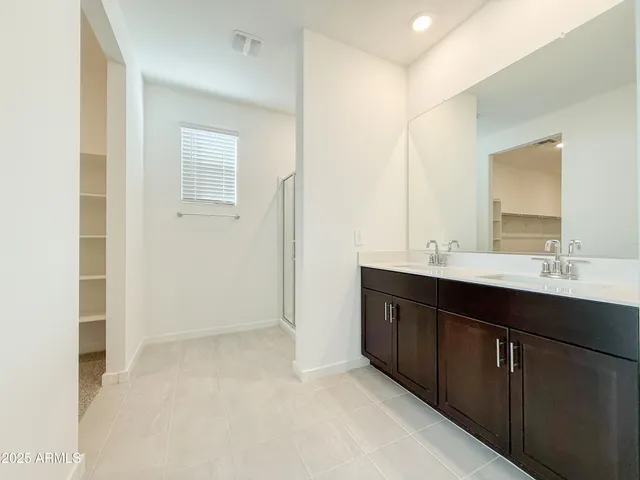a bathroom with a sink vanity and mirror