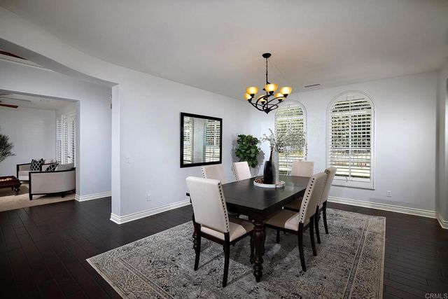 a view of a dining room with a table and chairs