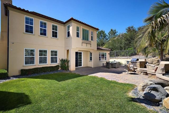 a view of backyard with a table and chairs