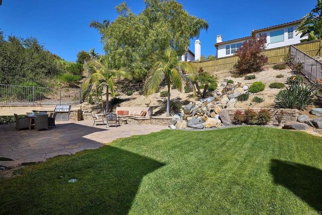 a view of a patio with couches and a fire pit