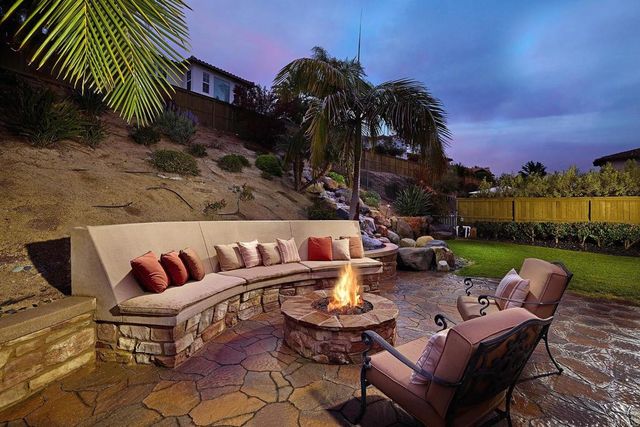 a view of a patio with couches chairs and a fire pit