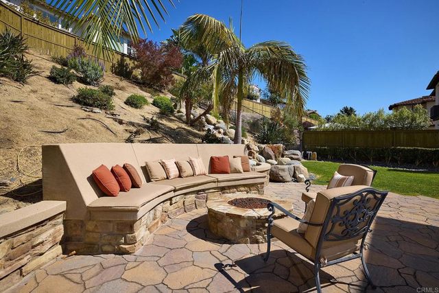 a view of a patio with table and chairs and potted plants