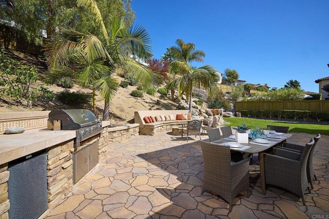 a front view of a house with outdoor seating