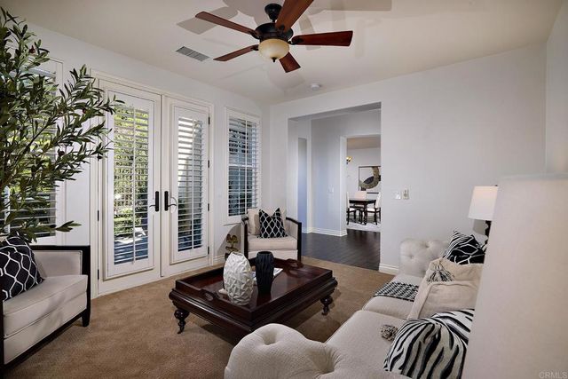 a living room with furniture and a potted plant