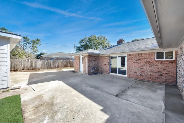 a view of a house with a yard and a garden