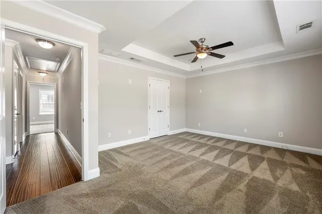 a view of a livingroom with a ceiling fan and wooden floor