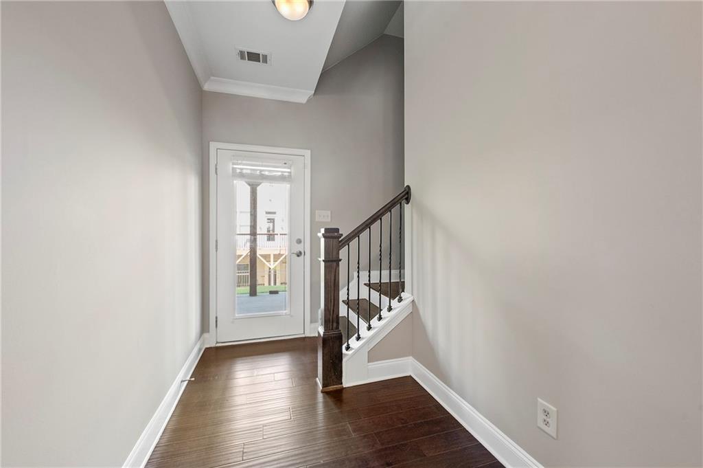 2140 Coventry Drive Brookhaven, GA 30319 - Photo 19 of 29 a view of a hallway with wooden floor and stairs