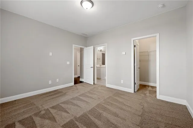 an empty room with closet and a bathroom