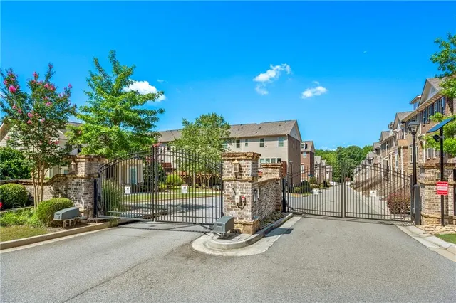 a view of a house with backyard and a tree