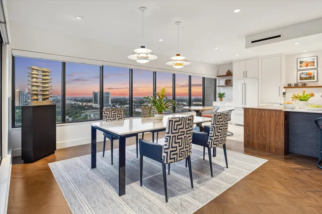 a living room with furniture tv and large windows
