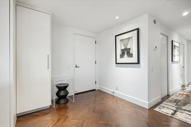 a living room with stainless steel appliances furniture a dining table and chairs