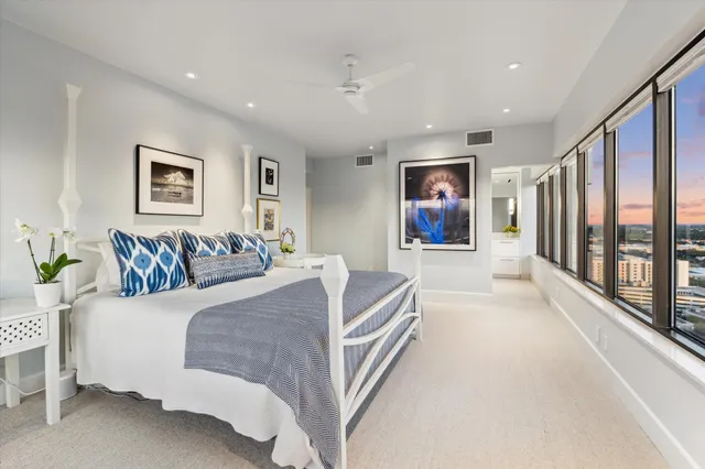 a spacious bedroom with a large bed and a couch