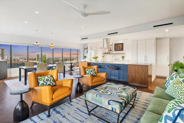 a kitchen with a large counter top stainless steel appliances and a large window