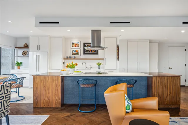 a living room with furniture kitchen view and a window