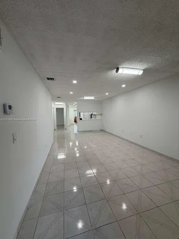 a kitchen with stainless steel appliances a refrigerator sink and cabinets