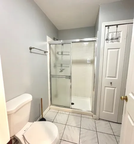 a bathroom with a glass shower door