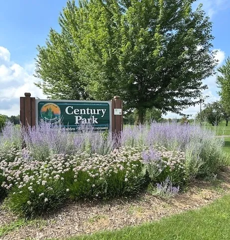 a street sign that is in front of flowers