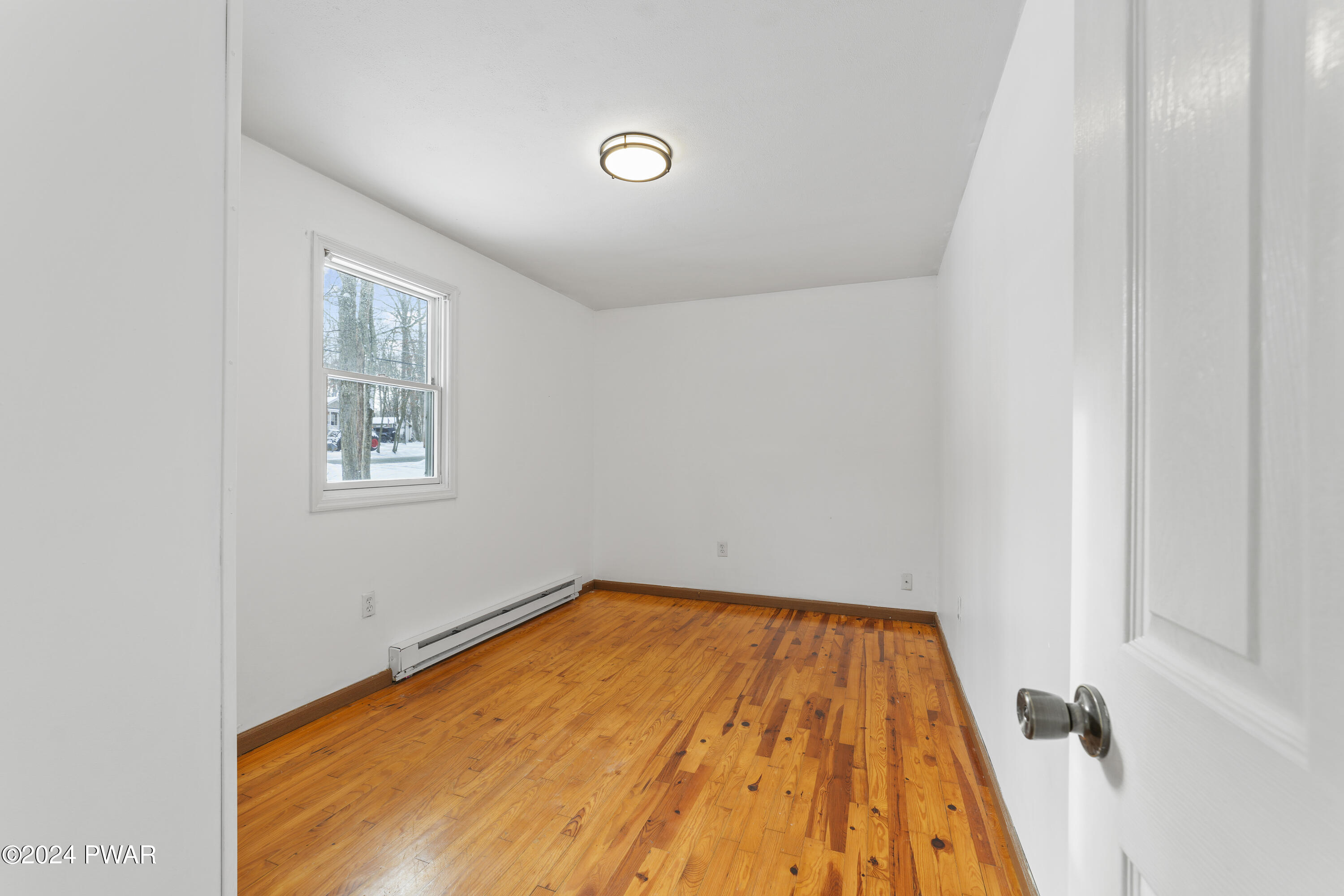 127 Slaymaker Road Milford, PA 18337 - Photo 15 of 22 a view of a big room with wooden floor and windows
