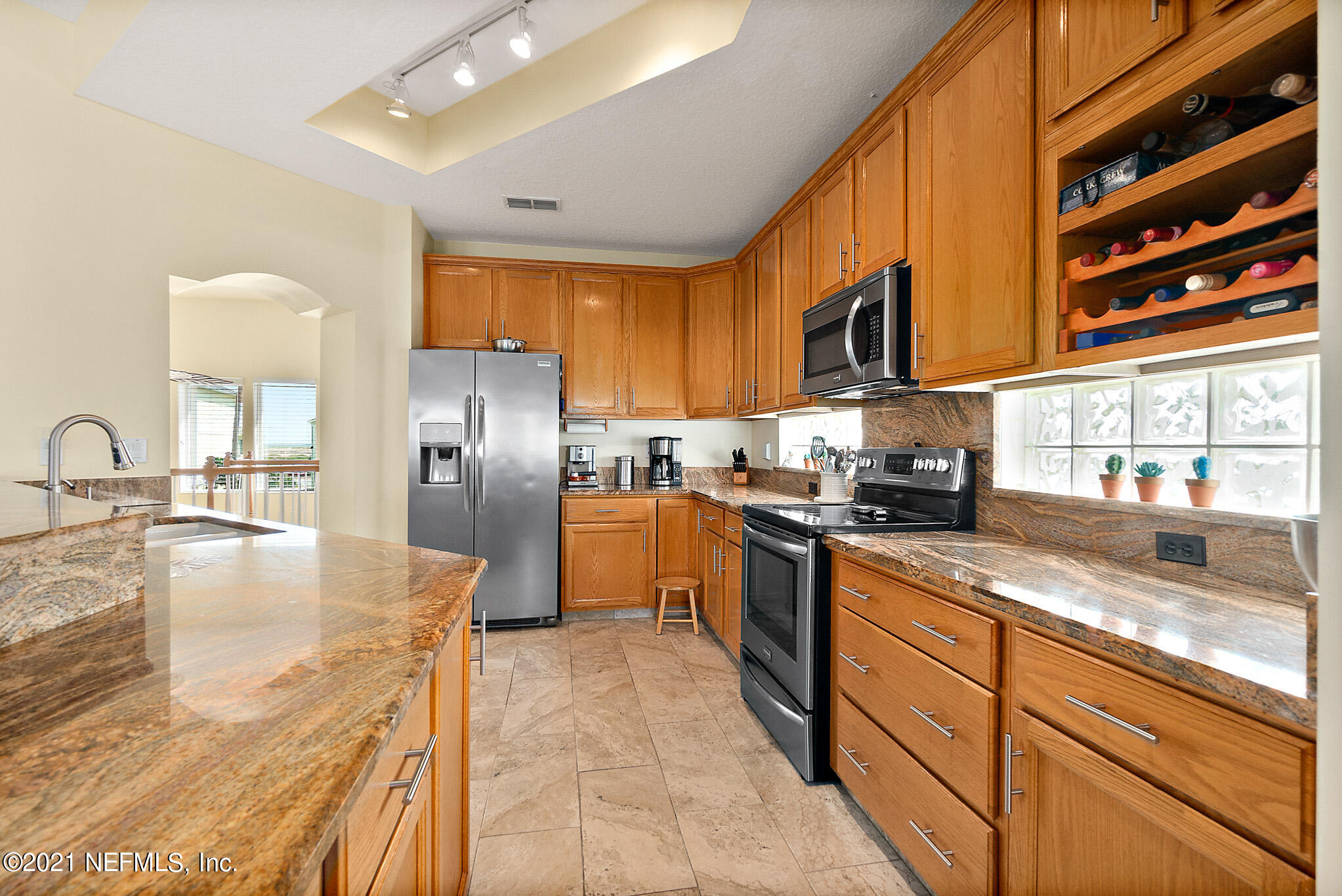 9269 July Lane St. Augustine, FL 32080 - Photo 36 of 105 a kitchen with stainless steel appliances granite countertop a sink a stove and a refrigerator