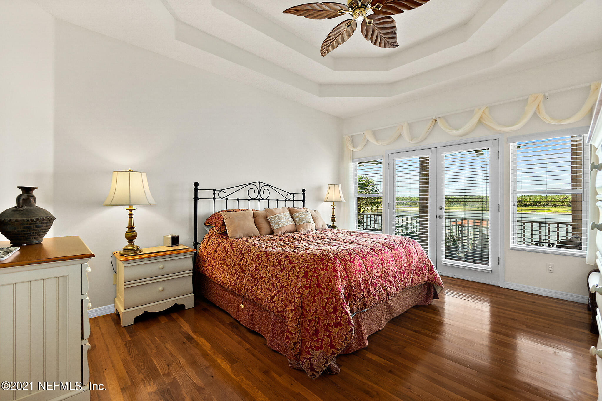 9269 July Lane St. Augustine, FL 32080 - Photo 39 of 105 a bedroom with a bed and a large window with wooden floor