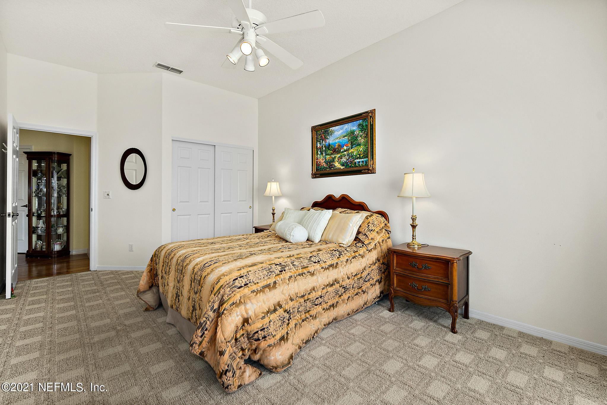 9269 July Lane St. Augustine, FL 32080 - Photo 50 of 105 a bedroom with a bed and a lamp on table