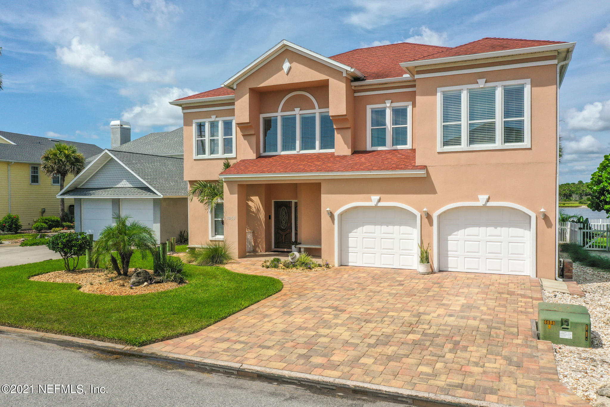 9269 July Lane St. Augustine, FL 32080 - Photo 76 of 105 a front view of a house with a yard and garage