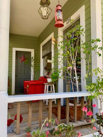 a view of a house with a deck and furniture