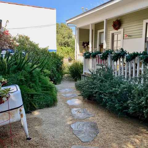 a view of a house with yard and sitting area